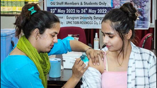 A healthcare worker administers a dose of the Covid-19 preventive vaccine to a beneficiary, at a vaccination camp in Gurugram. (PTI)