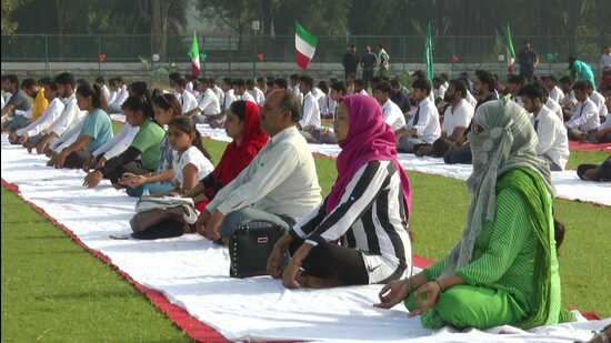 Over 2,000 participants, including students from various madrasas, Ahmadi School for the Visually Challenged, specially abled people and residents of old age homes, participated in the Yoga Utsav at AMU on Wednesday. (HT Photo)