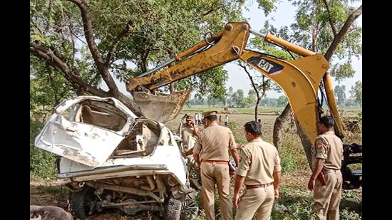 Policemen inspect after an SUV collided with a truck, in Barabanki on Wednesday. At least four people died in the accident, according to police. (PTI)