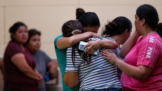 People mourn outside of the SSGT Willie de Leon Civic Center following the mass shooting at Robb Elementary School in Uvalde, Texas.
