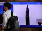 A man walks past a TV broadcasting a news report on North Korea's launch of three missiles, in Seoul.&nbsp;