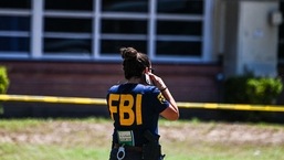 An FBI agent is seen outside Robb Elementary School in Uvalde, Texas, on May 25, 2022.