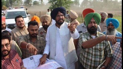 Cabinet minister Kuldeep Singh Dhaliwal (centre) at Talwandi Nauabad village in Sidhwan Bet area where 86 acres of illegally occupied government land was freed on Thursday. (HT Photo)
