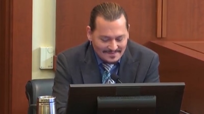Johnny Depp smiling as he talked about missing the tip of his severed finger in court. Johnny Depp smiling as he talked about missing the tip of his severed finger in court.