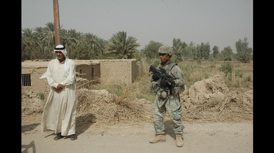 US soldiers conducting a patrol and setting up a checkpoint at Taji in Iraq on 13 August, 2008. (Shutterstock)
