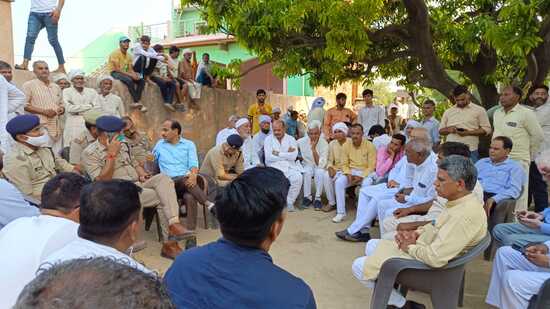 Baghpat DM Rajkamal Yadav and SP Neeraj Kumar Jadaun interacting with residents of village Bachaud after death of a woman and her two daughters who consumed poison during raid of police at their house on Tuesday evening. (HT PHOTO)