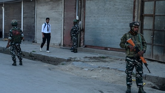 paramilitary troopers stand guard in front of closed shops during the second day of spontaneous strike in parts of Srinagar on Thursday.(AFP)