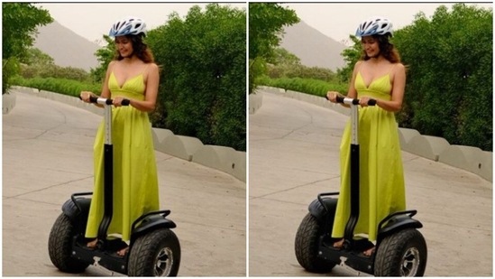 Kriti tried out riding on the streets of Udaipur. In a neon gown, the actor looked vacay-ready.(Instagram/@kriti.kharbanda)