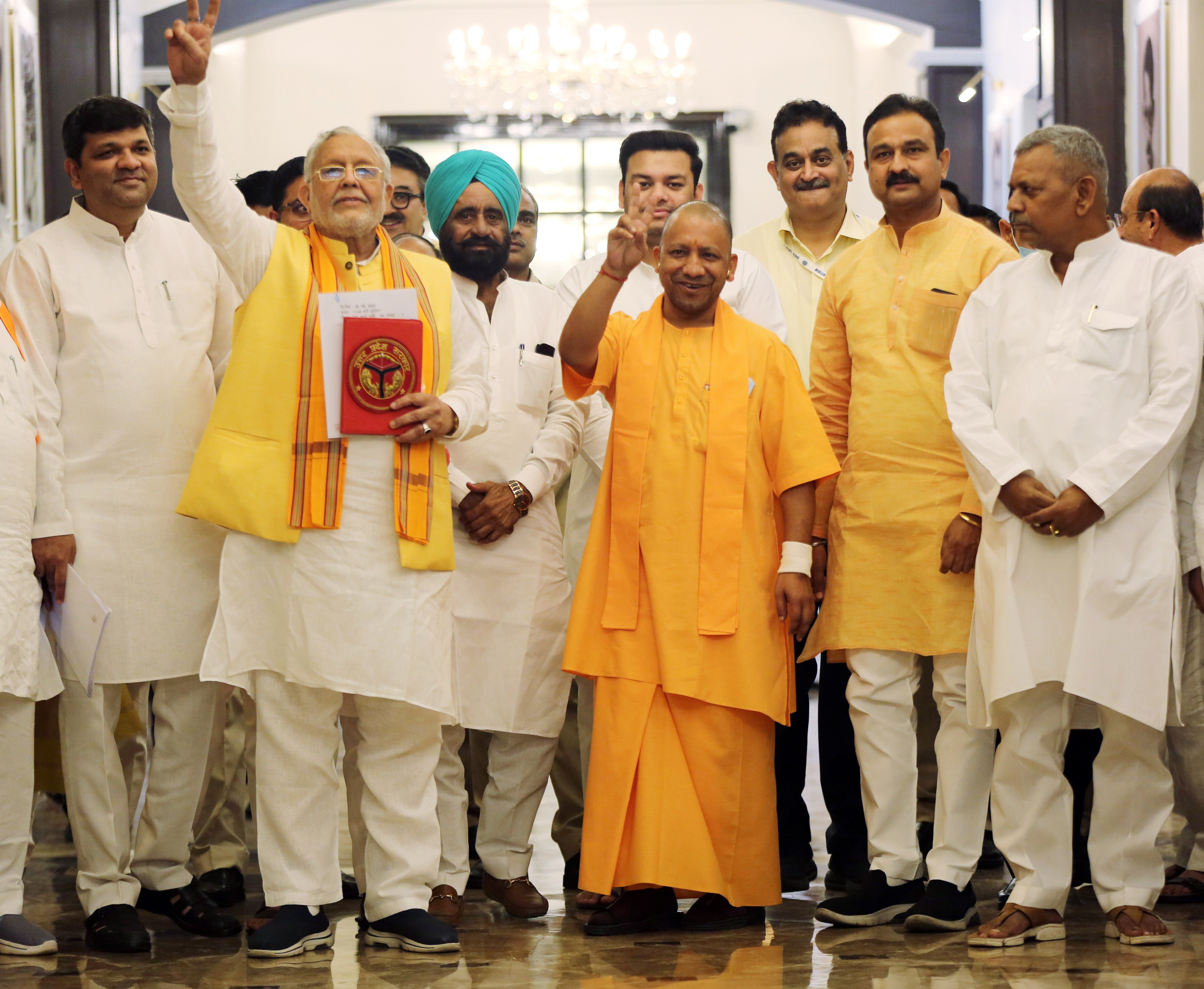 Uttar Pradesh finance Minister Suresh Khanna shows victory signs along with chief minister Yogi Adityanath as he arrives to present the State Budget 2022-23 during the budget session of the state assembly, in Lucknow.&nbsp; (ANI)