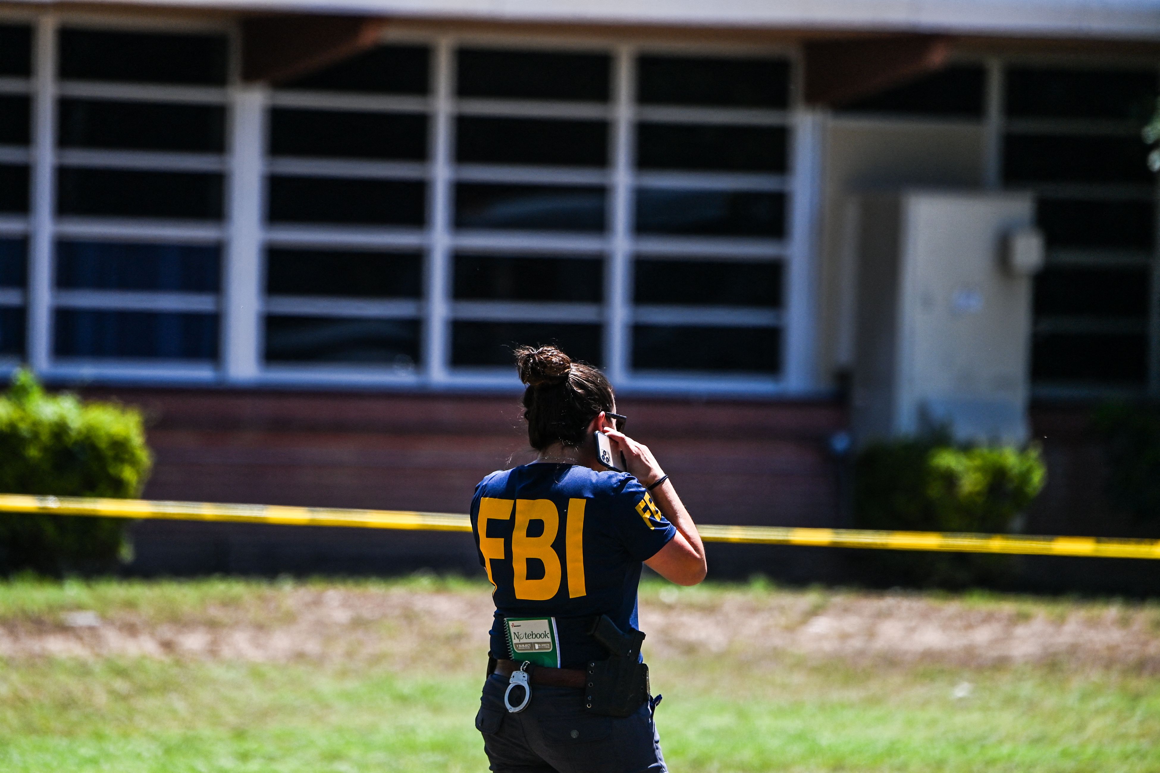 An FBI agent is seen outside Robb Elementary School in Uvalde, Texas, on May 25, 2022. (AFP) An FBI agent is seen outside Robb Elementary School in Uvalde, Texas, on May 25, 2022. (AFP)