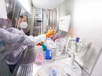 An employee works on a vaccine based on the monkeypox vaccine that has already been developed by the vaccine company Bavarian Nordic at a laboratory of the company in Martinsried near Munich, Germany.