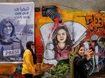 Two women take a selfie at an art exhibit honouring her late colleague Palestinian journalist Shireen Abu Akleh in Jenin city in the occupied West Bank.