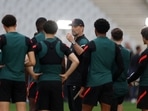 Liverpool manager Juergen Klopp talks to his players during training