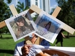 A person holds pictures of victims of the Texas shooting as they protest against gun laws outside the National Rifle Association (NRA) annual convention in Houston, Texas.