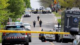 Police officers work at the scene where police shot and injured a suspect who was walking down a city street carrying a gun, as four nearby schools were placed on lockdown, in Toronto, Ontario, Canada. (REUTERS)