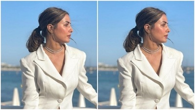 Hina teamed an ivory white short pencil skirt with a white blazer. The dress also featured a tulle train at the back. (Instagram/@realhinakhan)