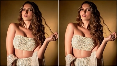 Tara slipped into a beige strapless bralette and lehenga set for attending Karan's star-studded birthday bash. The top comes with a plunging sweetheart neckline, cropped hem showing off the star's midriff and a fitted silhouette. It also features shimmering diamantes in ice blue, pearl white and golden shades decorated in a bustier-shaped pattern. (Instagram/@tarasutaria) Tara slipped into a beige strapless bralette and lehenga set for attending Karan's star-studded birthday bash. The top comes with a plunging sweetheart neckline, cropped hem showing off the star's midriff and a fitted silhouette. It also features shimmering diamantes in ice blue, pearl white and golden shades decorated in a bustier-shaped pattern. (Instagram/@tarasutaria)