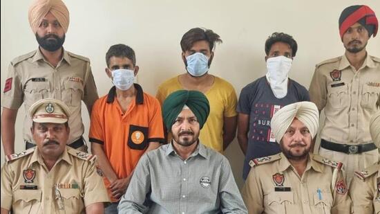 STF officials with three drug peddlers caught with heroin in separate cases, in Ludhiana on Friday. (HT Photo)