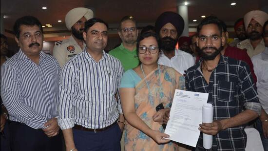 DC Surabhi Malik presenting offer letter to an applicant at the mega job fair in Ludhiana organised by CICU. (Harvinder Singh/HT)