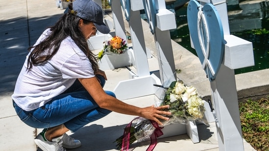 Meghan Markle places flowers as she mourns at a makeshift memorial outside Uvalde County Courthouse in Uvalde, Texas. (AFP)(AFP) Meghan Markle places flowers as she mourns at a makeshift memorial outside Uvalde County Courthouse in Uvalde, Texas. (AFP)(AFP)