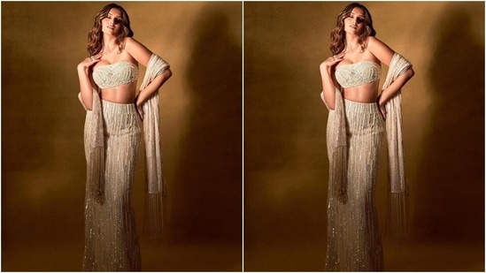 Tara paired the bralette with a matching skirt/lehenga featuring a fitted silhouette accentuating her enviable frame, mermaid-like fall, pearl and sequinned embellishments in gold, white, blue and silver shades, high-rise waistline and a floor-grazing hem.(Instagram/@tarasutaria)