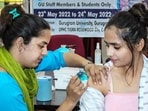 A healthcare worker administers a dose of the Covid-19 preventive vaccine to a beneficiary, at a vaccination camp in Gurugram. (PTI)