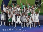 Real Madrid players celebrate with the trophy after winning the Champions League final Real Madrid players celebrate with the trophy after winning the Champions League final