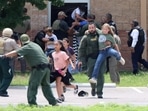 Children run to safety during a mass shooting at an elementary school where a gunman killed 19 children and two adults in Uvalde, Texas.