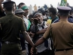 A man shouts against Sri Lankan President Gotabaya Rajapaksa as people block the main road in front of the president's secretariat during a protest against the worsening economic crisis.