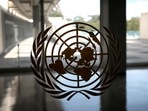 The United Nations logo is seen on a window in an empty hallway at United Nations headquarters.