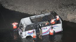 Rescue operation underway after a speeding minibus skidded off the road and fell into Tawi river in Jammu on Friday night. (PTI)
