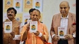 UP CM Yogi Adityanath releasing a book on Veer Savarkar in Lucknow on Saturday.  (HT)