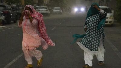 Two women caught amid strong winds witnessed in Ludhiana on Saturday. (HT Photo)