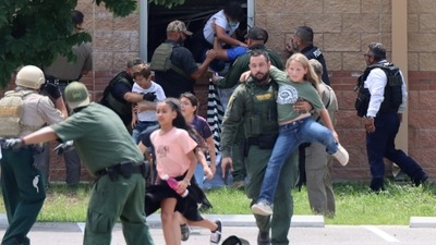 Children run to safety during a mass shooting at an elementary school where a gunman killed 19 children and two adults in Uvalde, Texas. (via Reuters)