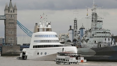Superyacht "Motor Yacht A", owned by Russian tycoon Andrey Melnichenko, is seen moored on the River Thames besides HMS Belfast (R) in London. (Reuters)