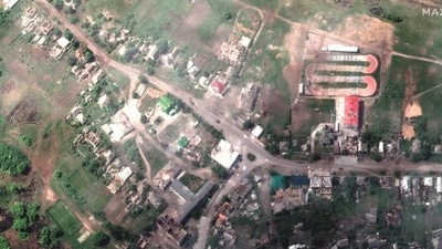A satellite image shows damaged buildings and a tank on a road, in Lyman, Ukraine May 25, 2022. (via REUTERS)
