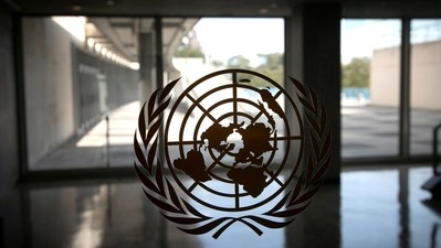 The United Nations logo is seen on a window in an empty hallway at United Nations headquarters. (REUTERS)