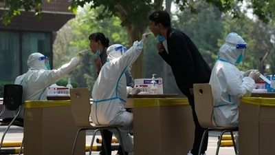 Residents get swabbed for mass Covid test in Beijing. (AP)