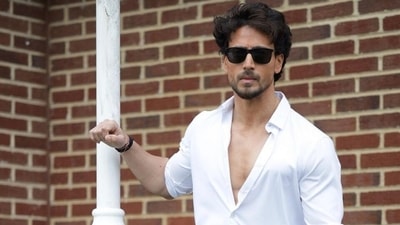 Tiger Shroff shows off his ripped muscles and nails dumbbell bicep curls in a new shirtless workout video (Instagram) Tiger Shroff shows off his ripped muscles and nails dumbbell bicep curls in a new shirtless workout video (Instagram)