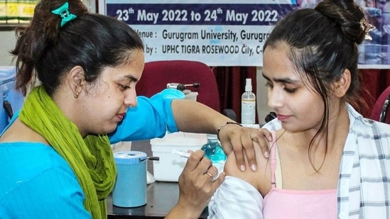 A healthcare worker administers a dose of the Covid-19 preventive vaccine to a beneficiary, at a vaccination camp in Gurugram. (PTI) A healthcare worker administers a dose of the Covid-19 preventive vaccine to a beneficiary, at a vaccination camp in Gurugram. (PTI)