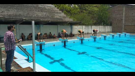 Athletes participating in the swimming trials at the Guru Nanak Stadium in Ludhiana on Saturday. (HT Photo)
