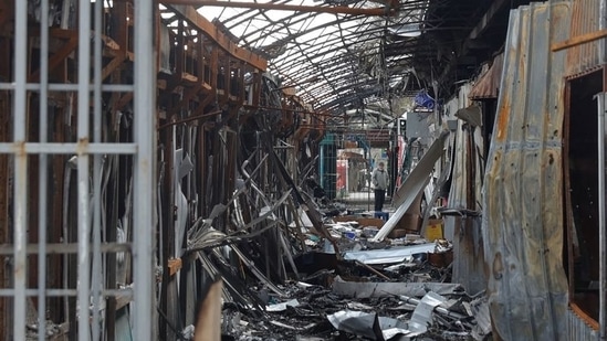 A local resident stands next to debris of an open market destroyed by a military strike, as Russia's attack on Ukraine continues, in Sievierodonetsk, Luhansk region. (File image)(REUTERS)