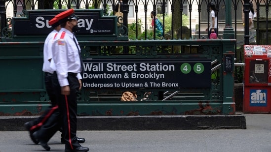 Security guards walk past the Wall Street subway station near the New York Stock Exchange (NYSE) in New York on May 27, 2022.&nbsp;(AFP)