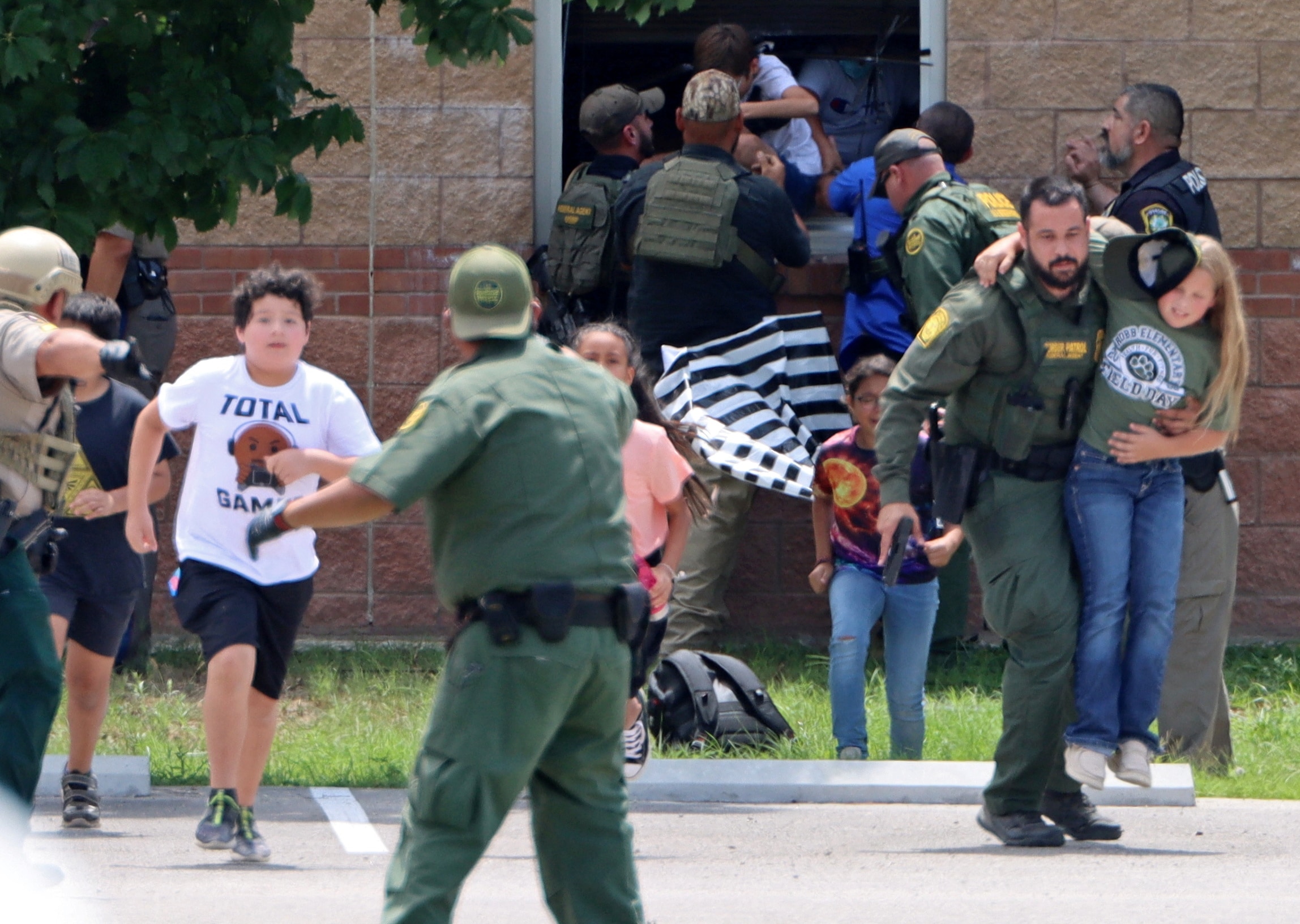 Children run to safety after escaping from a window during a mass shooting at Robb Elementary School where a gunman killed nineteen children and two adults in Uvalde, Texas, U.S. May 24. (via REUTERS)