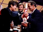 The 75th Cannes Film Festival - Closing ceremony - Cannes, France, May 28, 2022. Song Kang-ho, Best Actor award winner for his role in the film "Broker" (Les bonnes etoiles), director Ruben Ostlund, Palme d'Or award winner for the film film "Triangle of Sadness", and Vincent Lindon, Jury President of the 75th Cannes Film Festival, react on stage. REUTERS/Sarah Meyssonnier     TPX IMAGES OF THE DAY