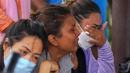 Family members and relatives of passengers onboard the Twin Otter aircraft operated by Tara Air react outside the airport in Pokhara on Sunday.