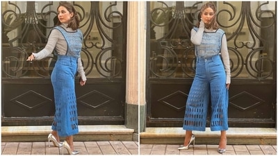 Hina's Cannes look features a grey coloured top with a high turtle neckline, long sleeves and bodycon silhouette. She tucked the high-neck top inside a pair of high-waisted light blue denim pants with flared hem and cut-out details. A black and blue mesh sleeveless top, layered over the ensemble, rounded off Hina's look. (Instagram) Hina's Cannes look features a grey coloured top with a high turtle neckline, long sleeves and bodycon silhouette. She tucked the high-neck top inside a pair of high-waisted light blue denim pants with flared hem and cut-out details. A black and blue mesh sleeveless top, layered over the ensemble, rounded off Hina's look. (Instagram)