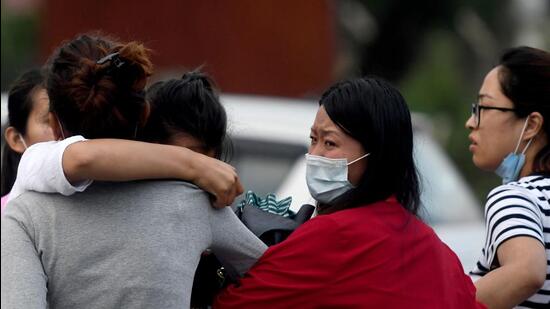 Family members and relatives of passengers on board the Twin Otter aircraft operated by Tara Air, weep outside the airport in Pokhara on Sunday, May 29, 2022. (AFP)