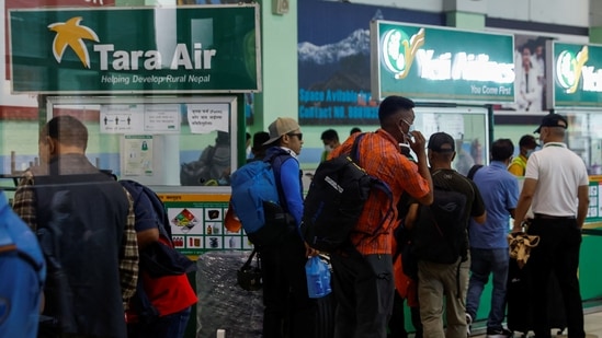 A group of mountaineers wait to board a flight at the Kathamnu airport. They are being deployed to the site in as they head to search and rescue of a plane operated by Tara Air that went missing.(REUTERS)