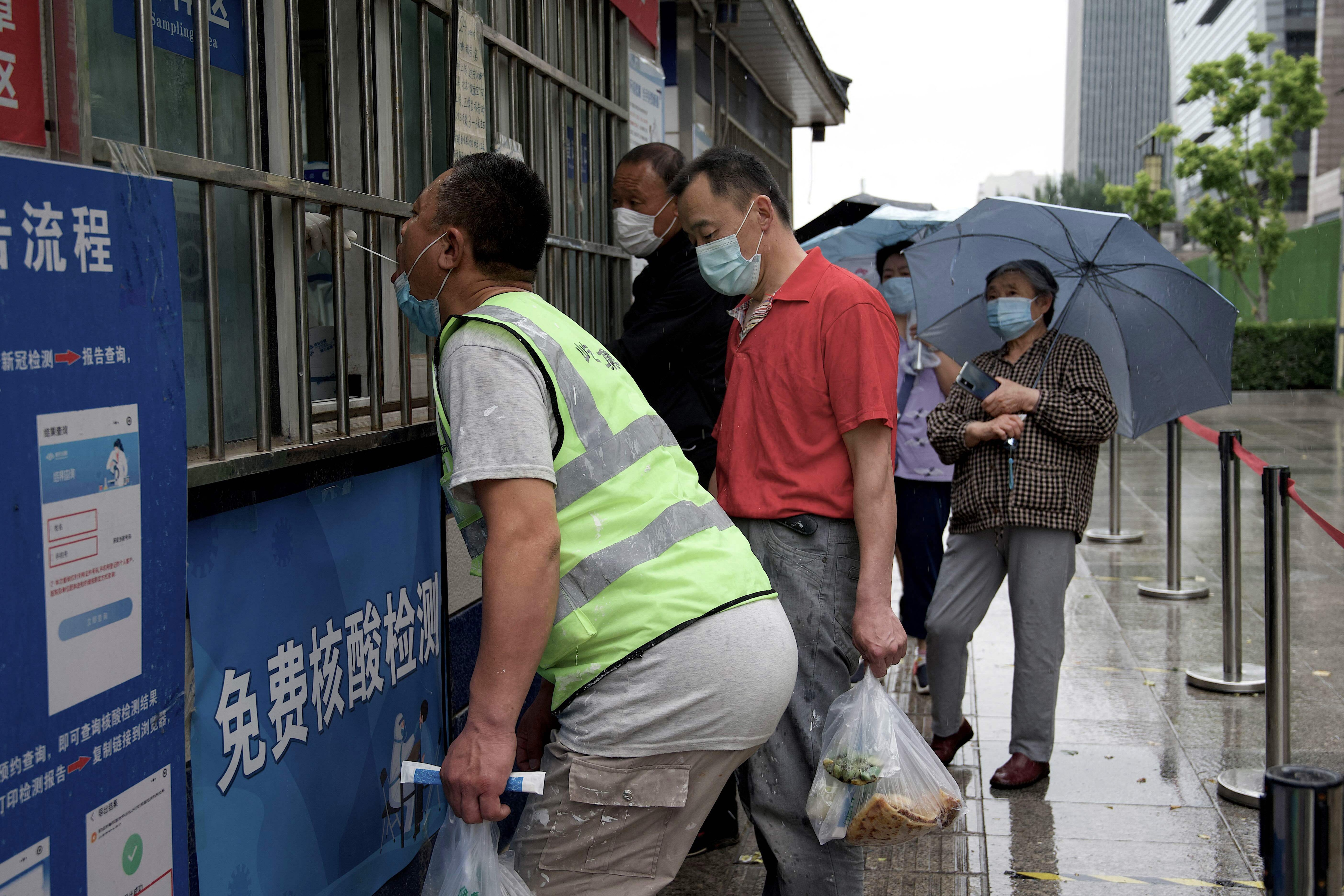 People queue to be tested for the Covid-19 coronavirus at a swab collection site in Beijing on Sunday. (AFP) People queue to be tested for the Covid-19 coronavirus at a swab collection site in Beijing on Sunday. (AFP)